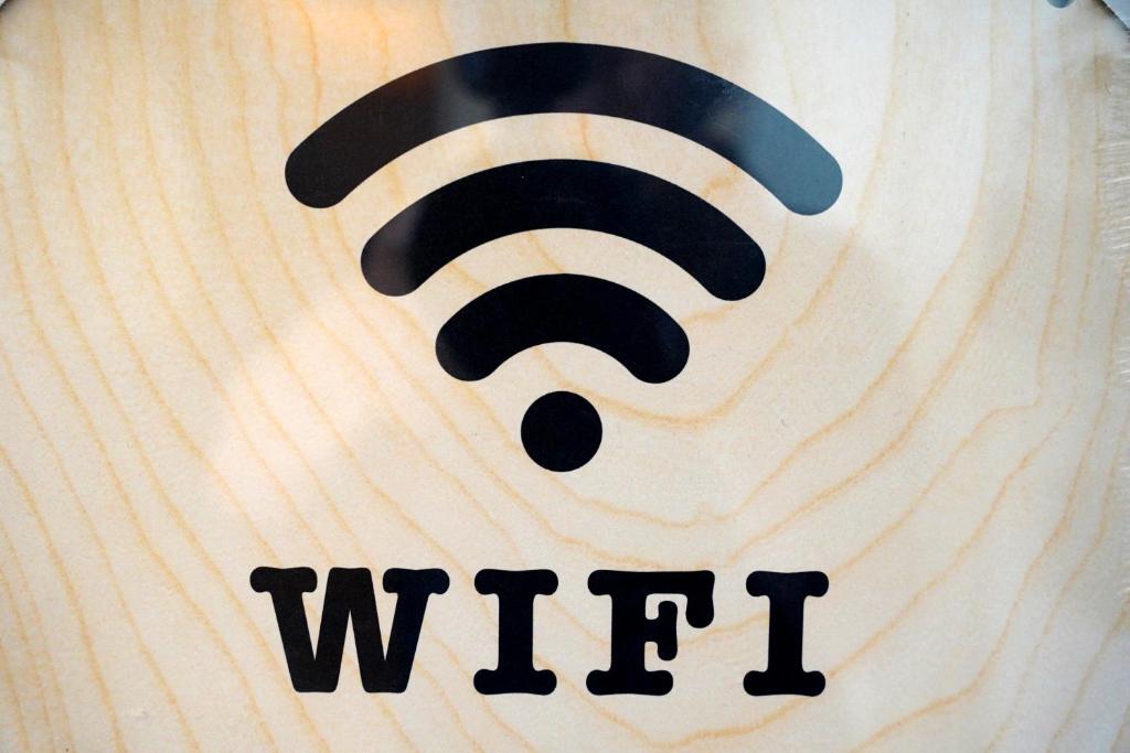 a wooden sign with an wifi symbol on it at The Maltese Sun in Sliema