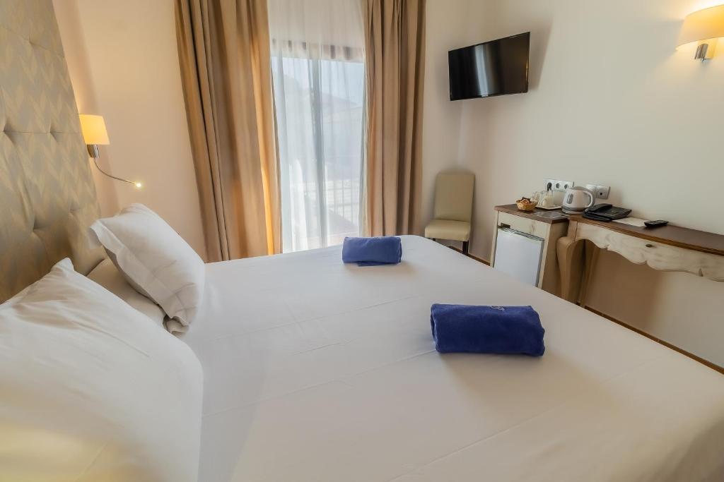 Posteľ alebo postele v izbe v ubytovaní Paloma Blanca Boutique Hotel