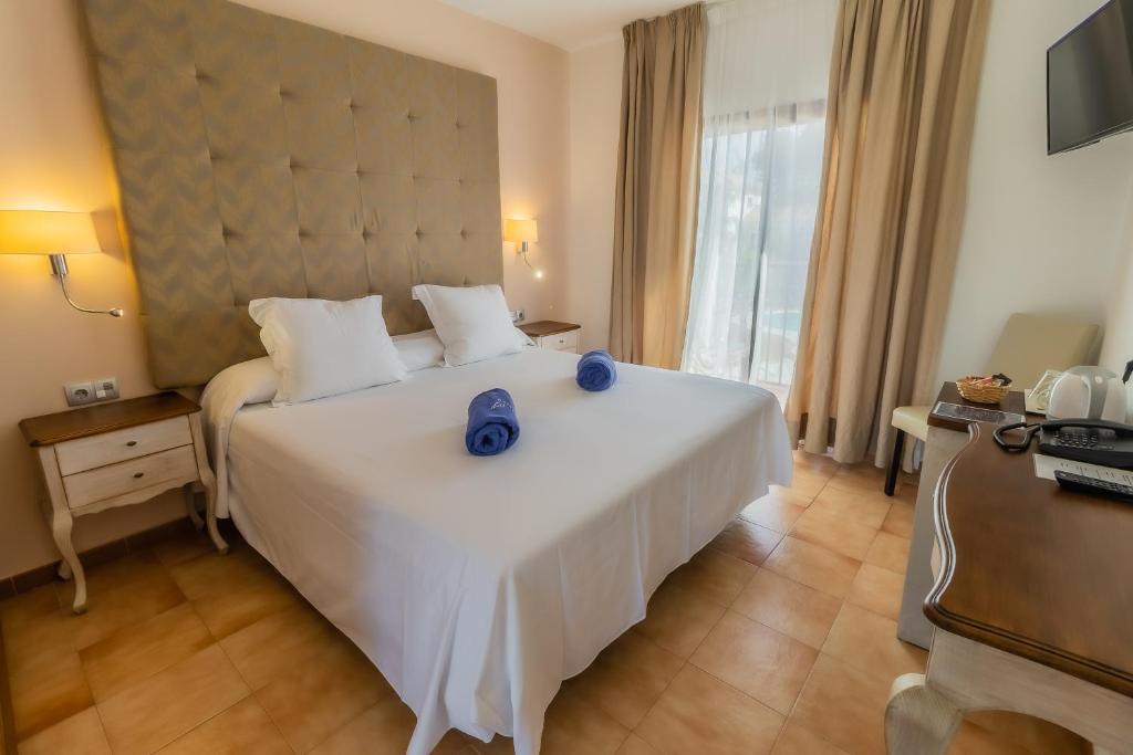 Posteľ alebo postele v izbe v ubytovaní Paloma Blanca Boutique Hotel