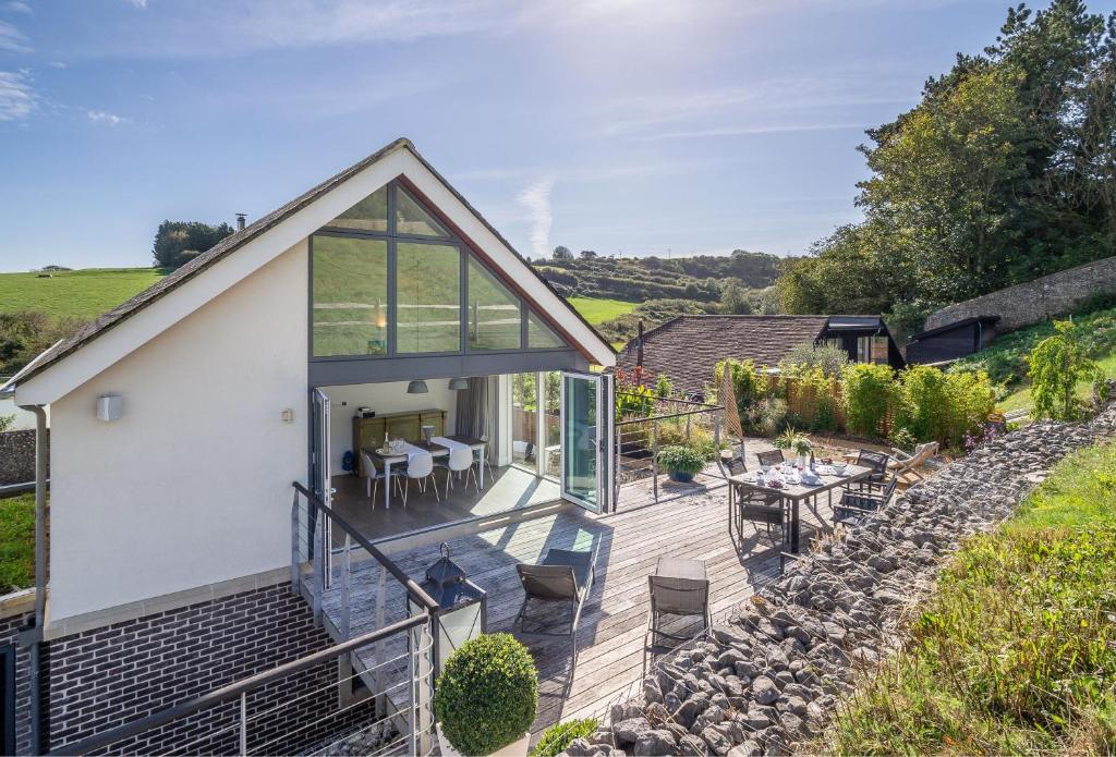 a home with a deck with a view of the backyard at Brooks Lodge Sussex in Tarring Neville