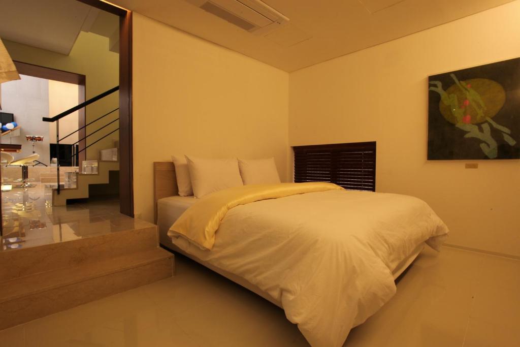 Postel nebo postele na pokoji v ubytování Yuwon Hotel