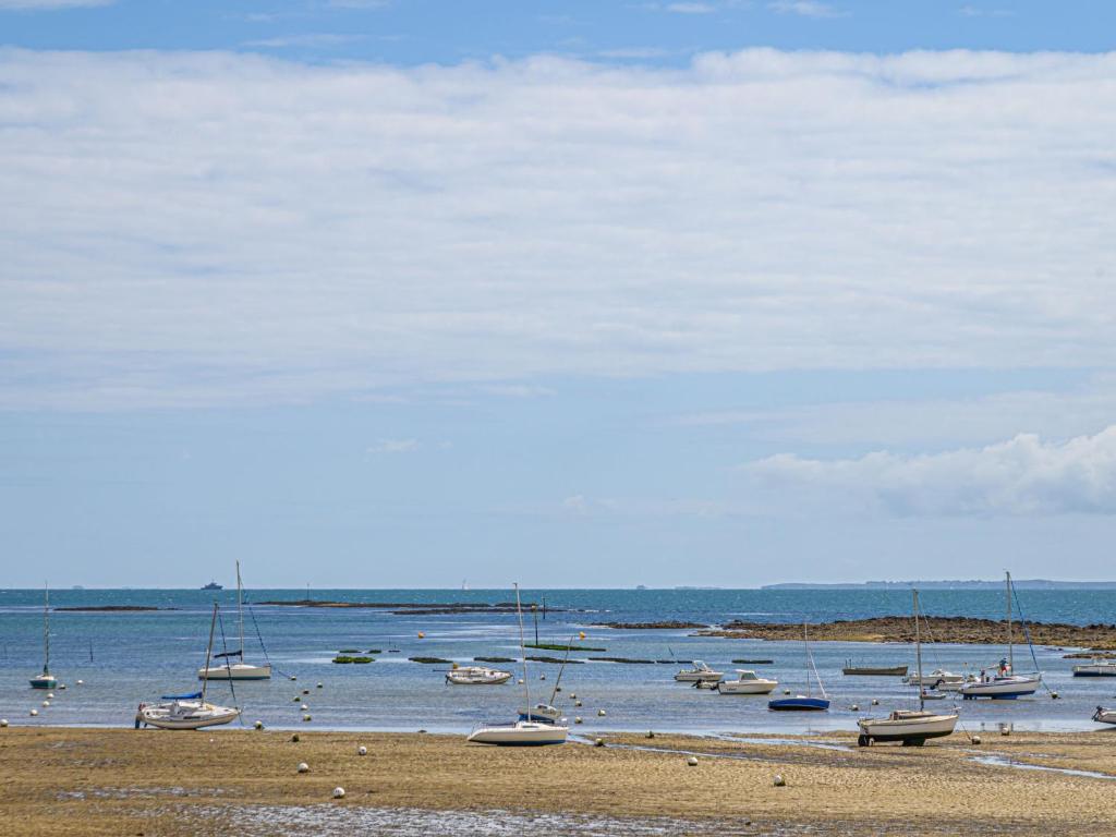 a group of boats in the water on a beach at Apartment Men Er Bellec-1 by Interhome in Saint-Philibert
