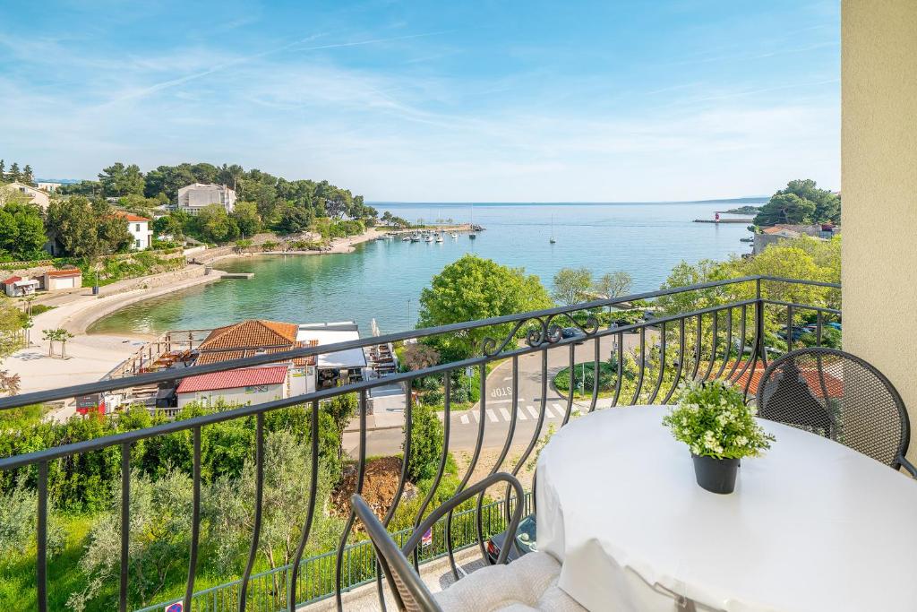 a balcony with a table and a view of the water at Apartment Jelka 2 in Krk