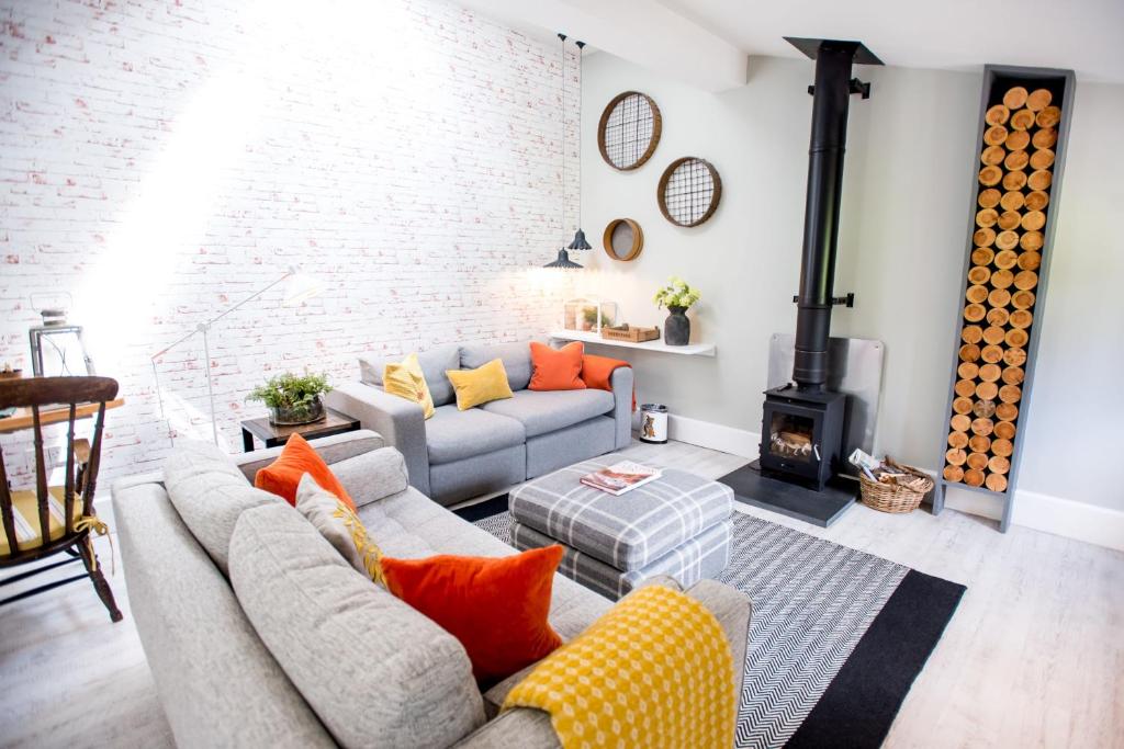 a living room with a couch and a fireplace at The Potting Shed in Weston under Lizard