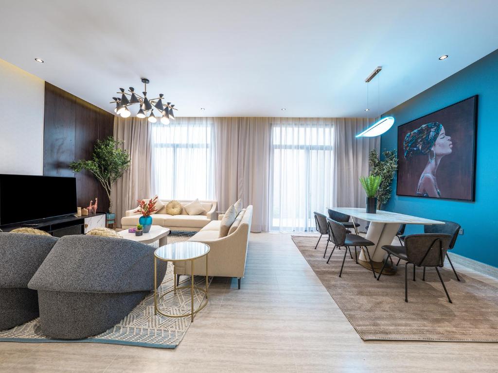 a living room with a couch and a table at Mabaat-Executive-Hittin 519 3BR-5-2 in Riyadh