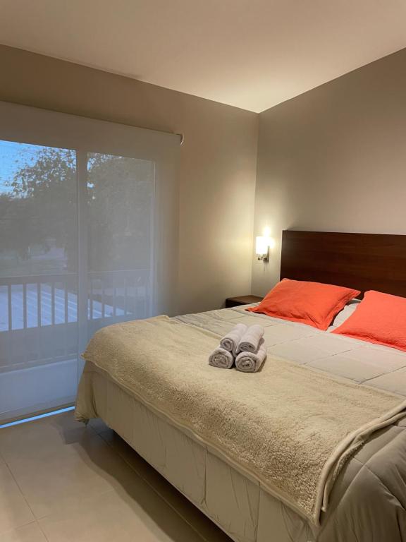 a bedroom with a large bed with towels on it at Duplex Renovado in San Juan