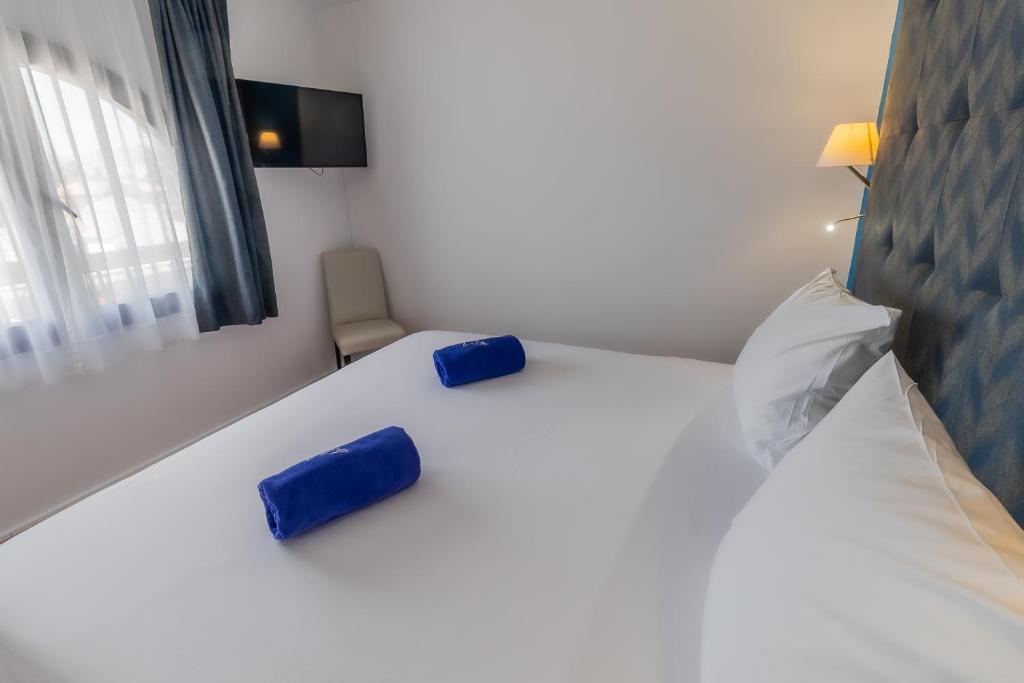 Posteľ alebo postele v izbe v ubytovaní Paloma Blanca Boutique Hotel