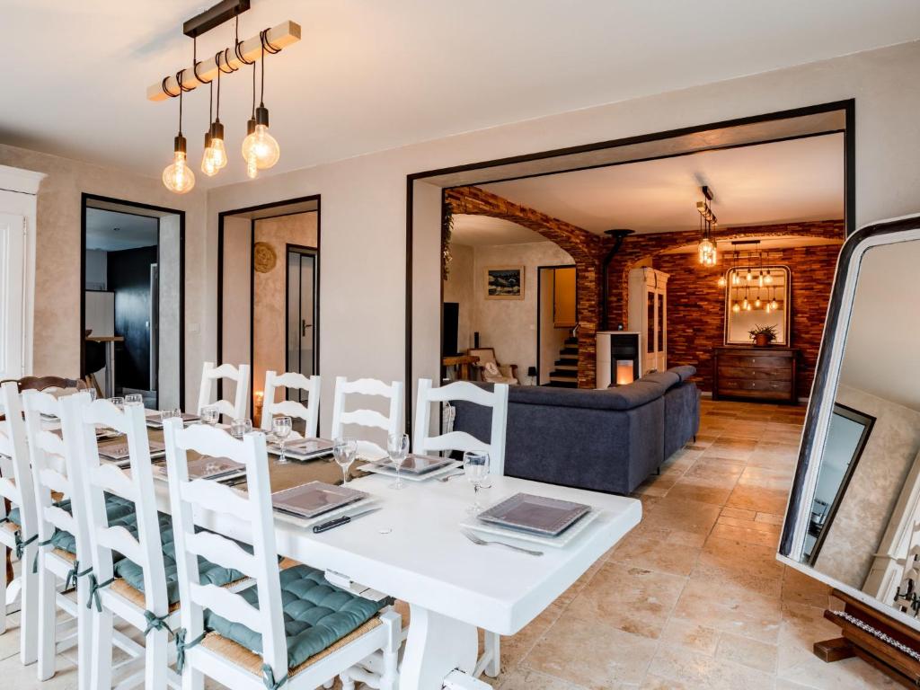 uma sala de jantar com uma mesa branca e cadeiras em Holiday Home La Villa bleue by Interhome em Merville-Franceville-Plage