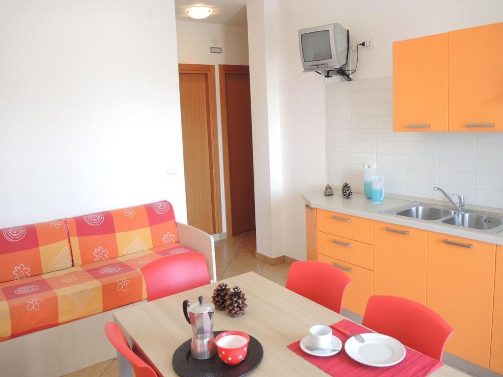 A kitchen or kitchenette at Colorful modern flat next to the beach - Beahost