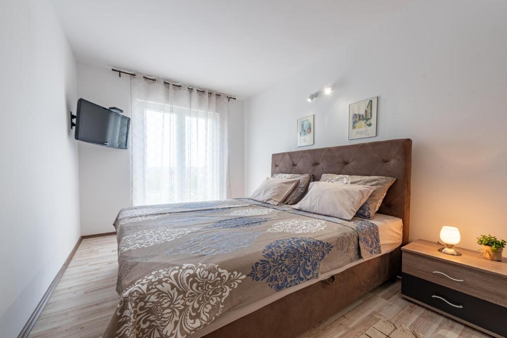 Łóżko lub łóżka w pokoju w obiekcie R&B Family Apartments