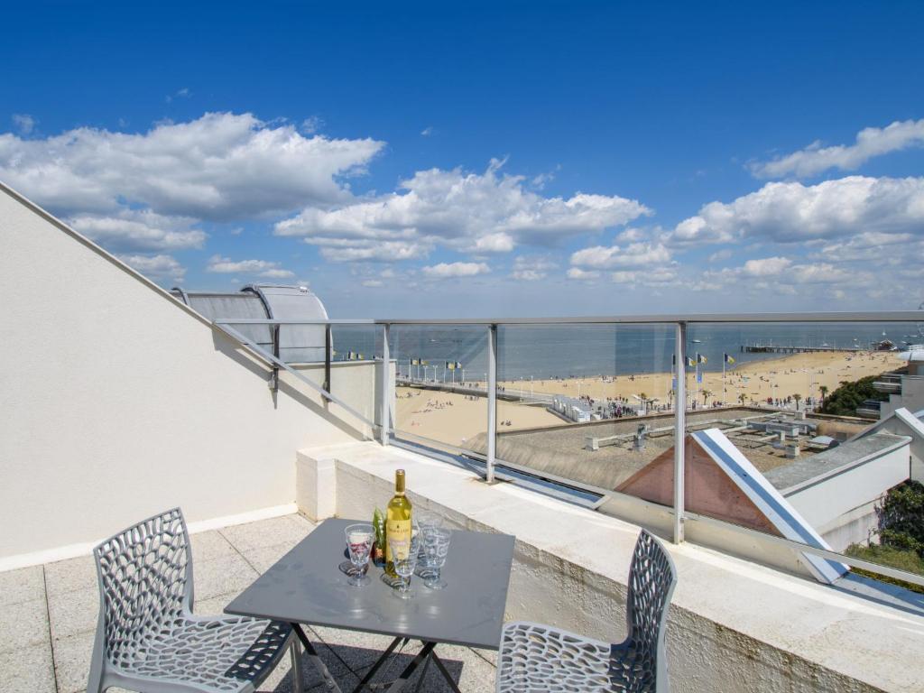 a balcony with a table and chairs and a view of the beach at Apartment Claire-4 by Interhome in Arcachon