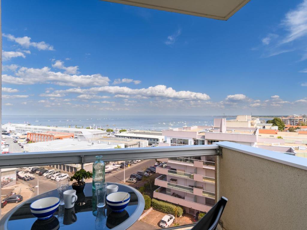 a balcony with a table and a view of a city at Studio Port Arcachon-6 by Interhome in Arcachon