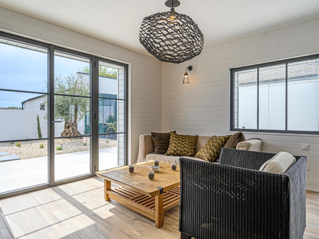 a living room with a couch and a table at Holiday Home Saint-Colomban-2 by Interhome in Carnac