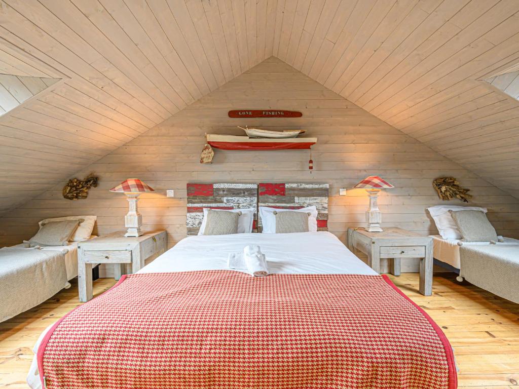 a bedroom with a large bed in a attic at Holiday Home Saint-Colomban-2 by Interhome in Carnac