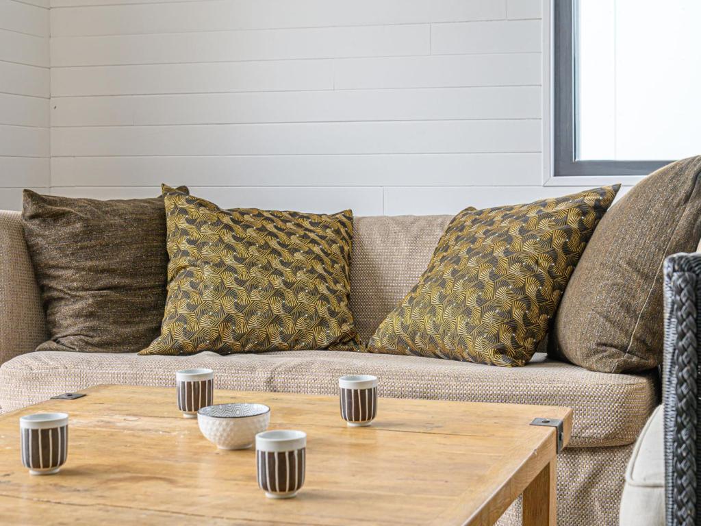 a living room with a couch and a wooden coffee table at Holiday Home Saint-Colomban-2 by Interhome in Carnac