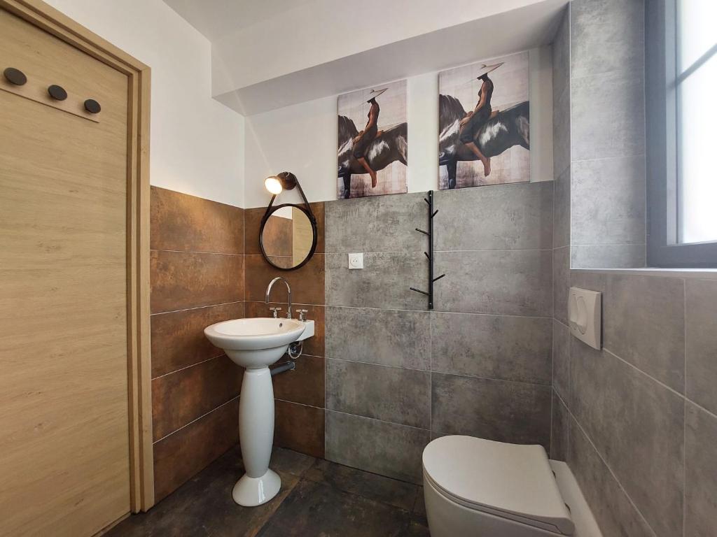 a bathroom with a white toilet and a sink at Holiday Home Saint-Colomban-2 by Interhome in Carnac