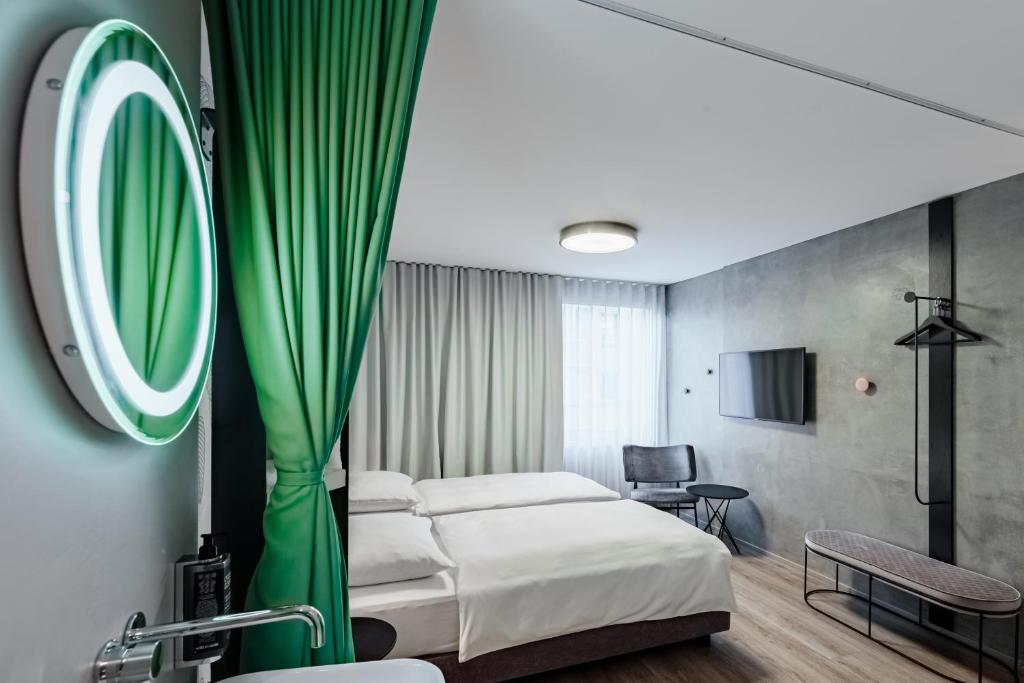 a hotel room with a bed and a mirror at ibis Styles Ljubljana Centre in Ljubljana
