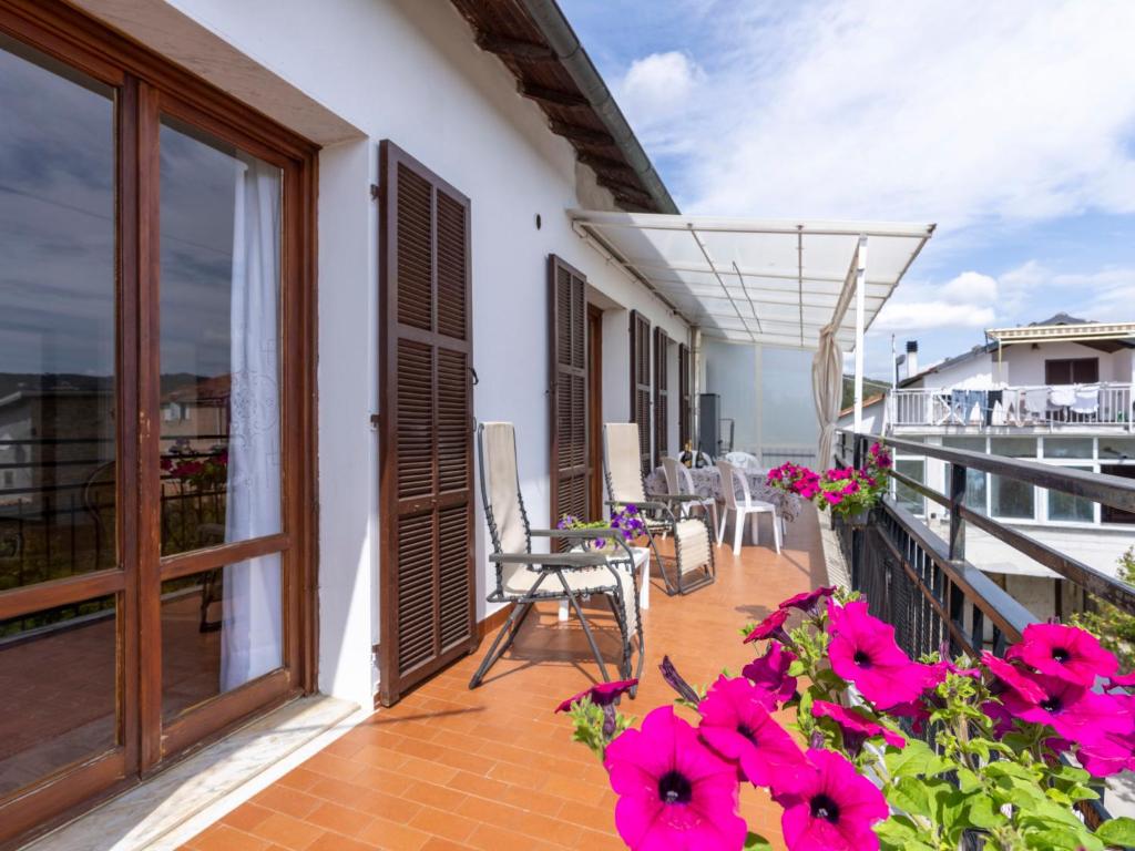 a balcony of a house with pink flowers at Apartment Relax by Interhome in Marina di Andora