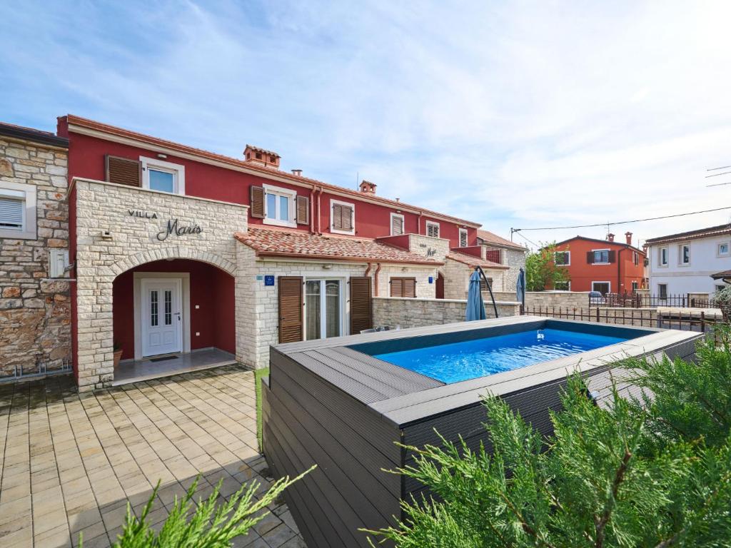 a house with a swimming pool in front of it at Holiday Home Villa Maris by Interhome in Brtonigla