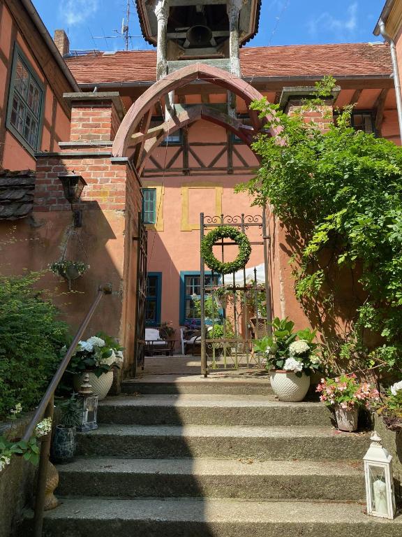an entrance to a building with stairs and plants at Wasserburg Turow in Glewitz