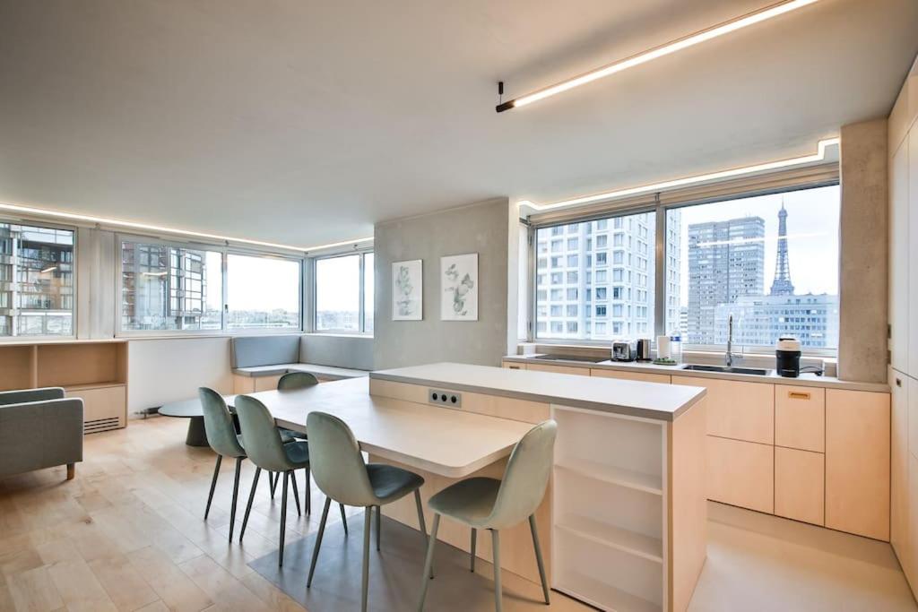 - une cuisine avec une table et des chaises ainsi que quelques fenêtres dans l'établissement Luxurious flat/3bedrooms/Amazing view/EffeilTower, à Paris