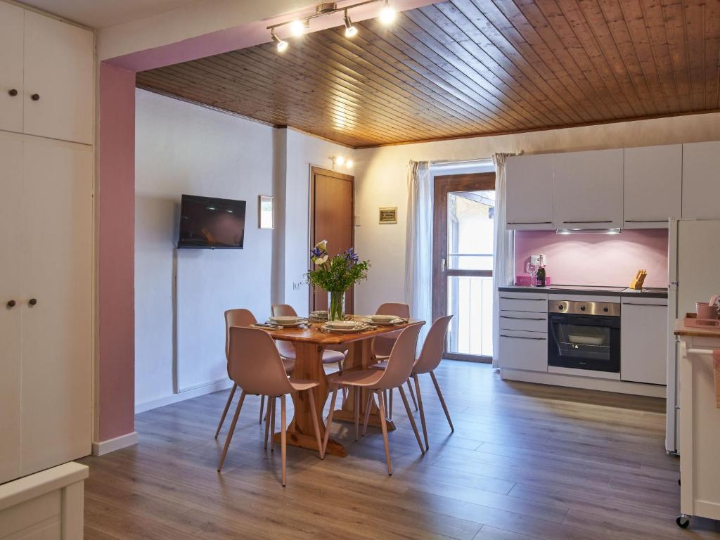 a kitchen and dining room with a table and chairs at Apartment Ca' Dolce Osteno by Interhome in Claino