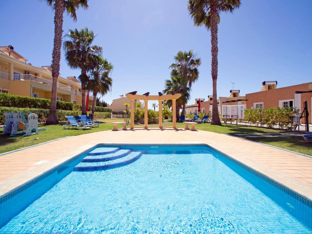 a swimming pool with a gazebo and palm trees at Holiday Home Sunset Terrace by Interhome in Pêra