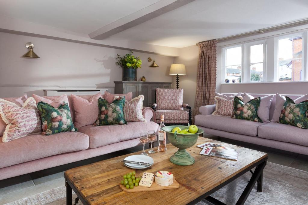 a living room with a couch and a table at The Gables in Cow Honeybourne