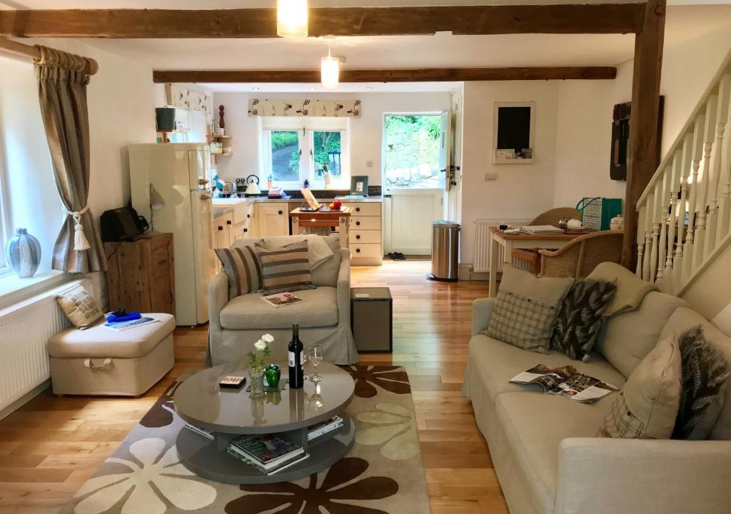 a living room with a couch and a table at The Old Paper Mill in Lintz Green