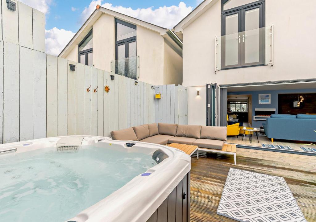 a hot tub in the backyard of a house at Coastal Dreams in St Ives