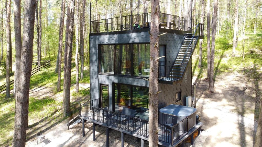 an aerial view of a tree house in the woods at Premium Forest Bungalow with HOT TUB in Ažuluokesa