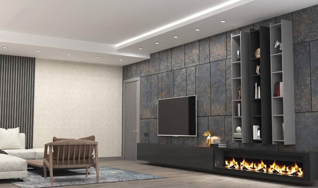 a living room with a tv and a fireplace at VIP Nizami EMIRATES in Baku
