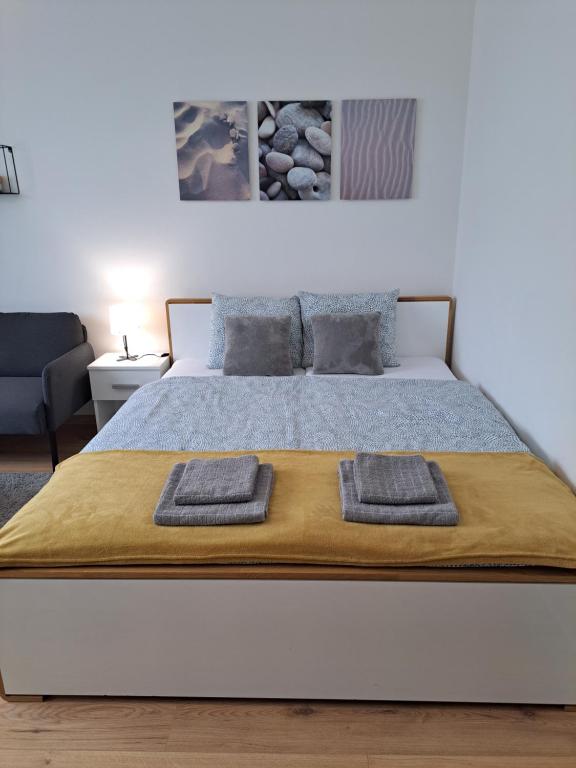 a bedroom with a bed with two towels on it at Adam apartmán in Košice