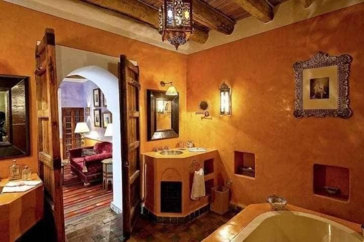 a large bathroom with a tub and a sink at DAR ELHADIR in Tozeur