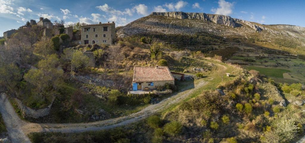 a house on a hill with a castle on it at La Bergerie du Haut Var in Bargème