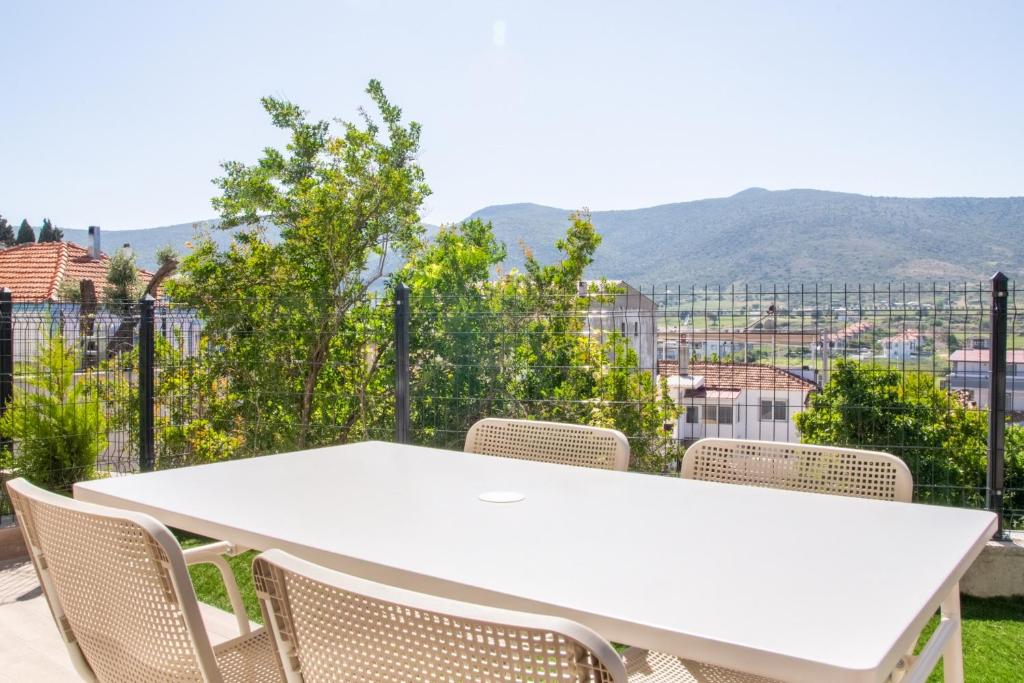 a white table and chairs with a view of a city at Natur in İzmir