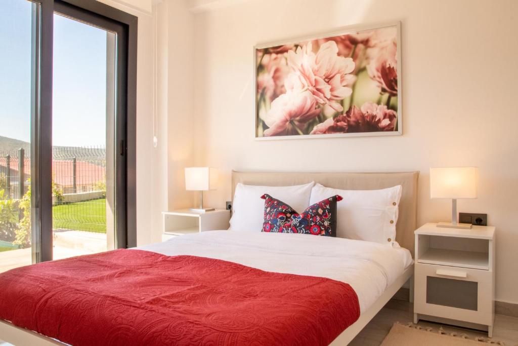 a bedroom with a large bed with a red blanket at Natur in İzmir