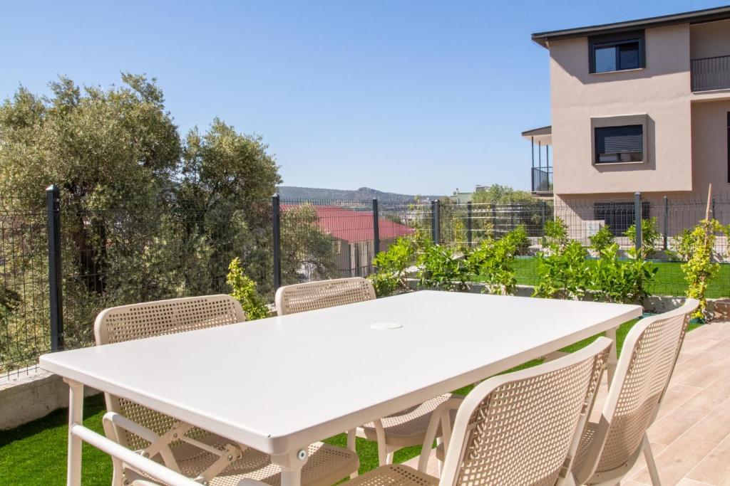 a white table and chairs on a balcony at Natur in İzmir