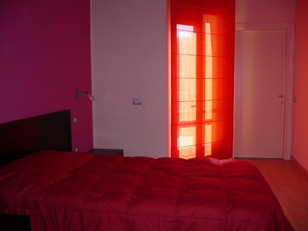 Łóżko lub łóżka w pokoju w obiekcie Hotel I Colori