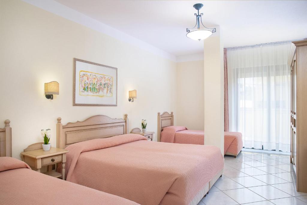 Postel nebo postele na pokoji v ubytování Hotel Maria Rosaria