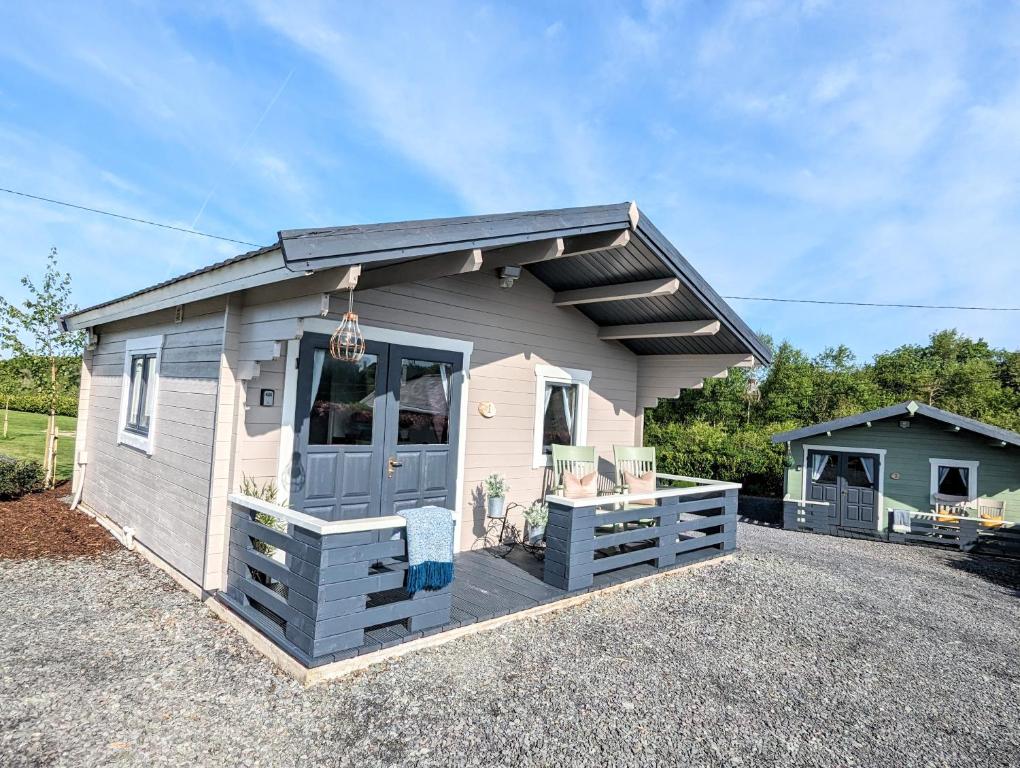 a tiny house with a blue door on a lot at Westport Country Chalets in Westport