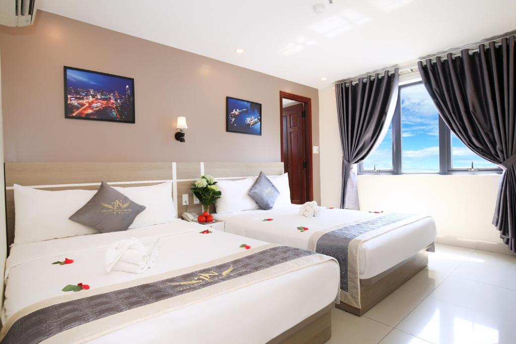 Postel nebo postele na pokoji v ubytování Thành Nhân Hotel