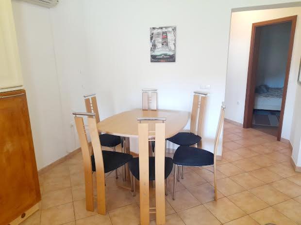 a dining table and chairs in a room with a table and chairsktop at APARTMANI DELAS in Pješčana Uvala