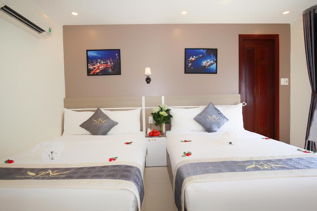 Postel nebo postele na pokoji v ubytování Thành Nhân Hotel