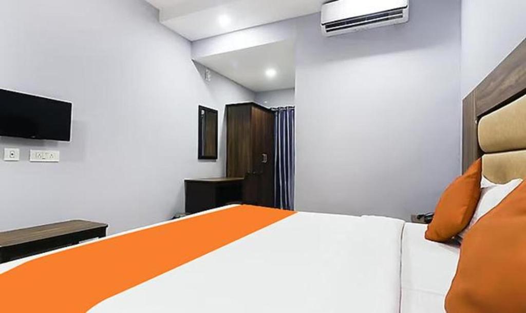 Postel nebo postele na pokoji v ubytování Queens Residency - Kochi