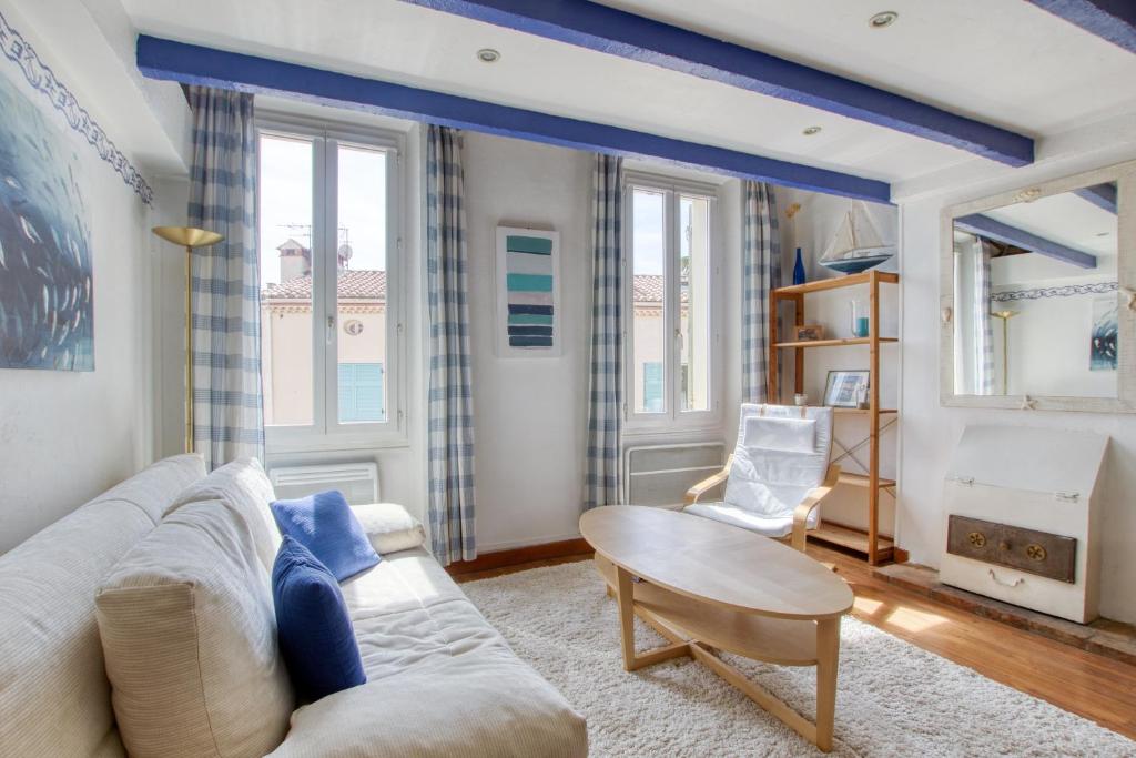 サナリー・シュル・メールにあるBleu Azur - avec vue sur le portのソファとテーブルのあるリビングルーム