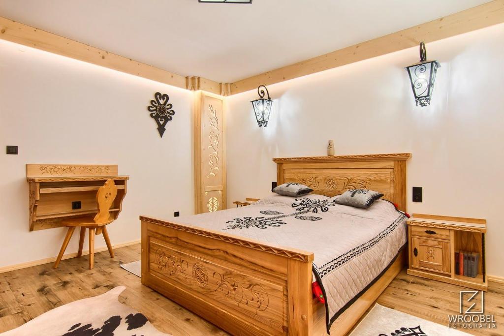 a bedroom with a wooden bed and a piano at Apartament Zakopane utrzymany w stylu góralskiej chaty in Zakopane