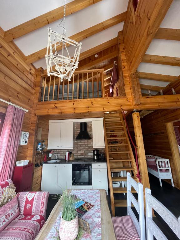 a living room and kitchen in a log cabin at Blockhaus an der Skiwiese Braunlage in Braunlage