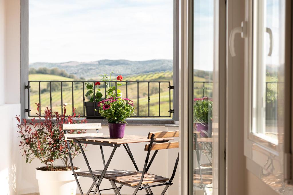 a table and chairs on a balcony with a view at Podere n.8 Bio Casale Maremma in Alberese