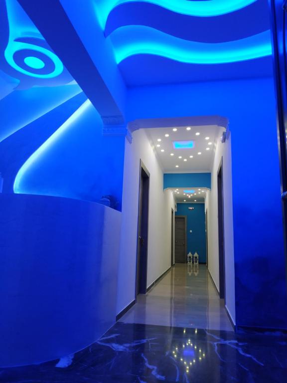 a hallway with blue lights on the ceiling at Alisaxni Studios in Argassi